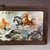 This framed artwork features a large, hand-painted porcelain tile depicting the famous traditional Chinese motif of the...