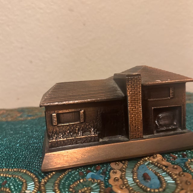 A striking Mid-Century Modern architectural model depicting a classic split-level or ranch-style home. Cast in solid white...