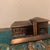 A striking Mid-Century Modern architectural model depicting a classic split-level or ranch-style home. Cast in solid white...