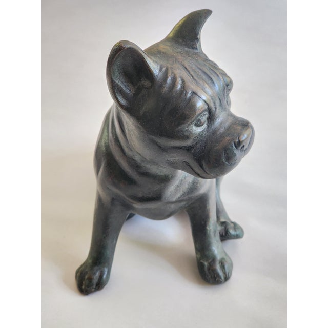 Maitland Smith Bronze Dog Dimensions: 8 1/4h x 7 1/4w x 5d in. Dark bronze metal with golden and verdigris patina. This...
