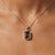 This sophisticated pendant features a rich and earthy Smoky Quartz gemstone, admired for its deep brown tones and subtle...