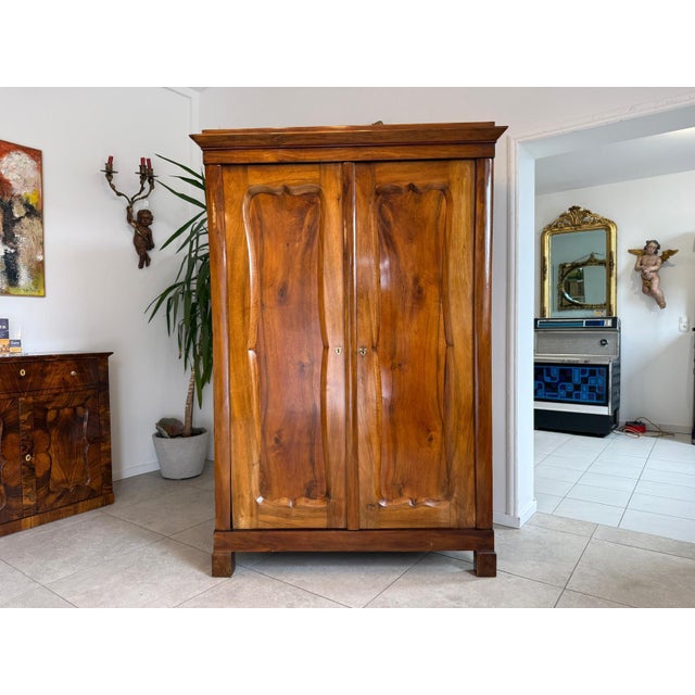 Original early 2-door Biedermeier wardrobe circa 1840. Dimensions: Height x Width x Depth 190 x 130 x 58 cm. For sale is...
