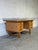 A substantial oak desk by Henning Kjærnulf pairs a broad rectangular top with two banks of three drawers. Sculpted drawer...
