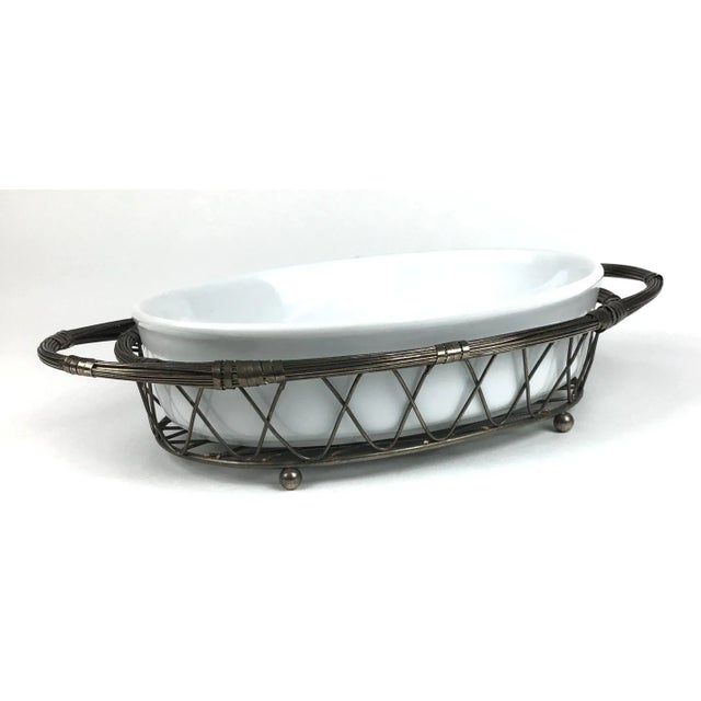 Unique silver wire threads woven to form a gorgeous holder for the pure white ceramic ovenproof dish. No marks for the...