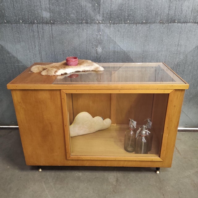 Originally used in a workwear clothing shop, this 1960s counter was the owner's pride—and it shows. with a glass display...