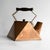 ANTIQUE COPPER KETTLE Casting an angular silhouette with triangular and diamond shapes throughout in the modernist taste....