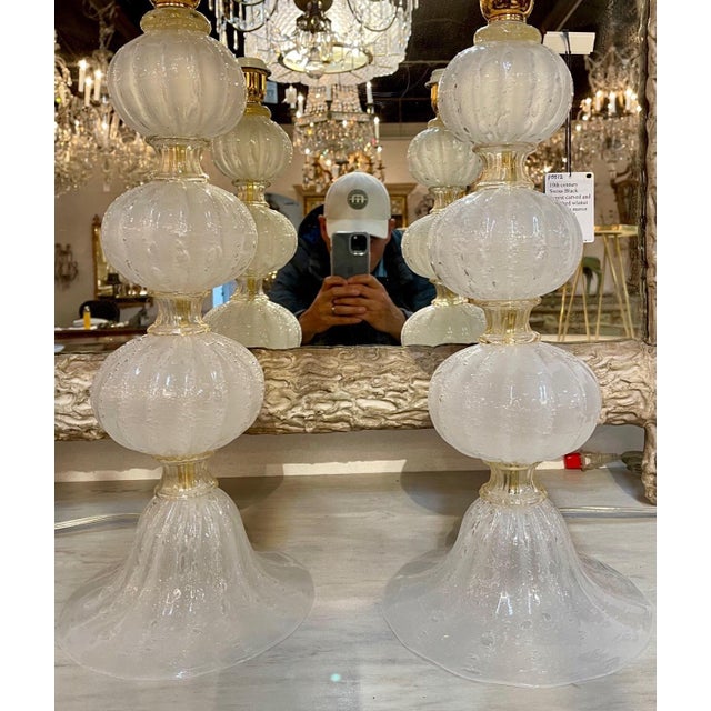 Gorgeous pair of frosted Murano glass ball form lamps. Touches of gold in between each section. A stunning pair!