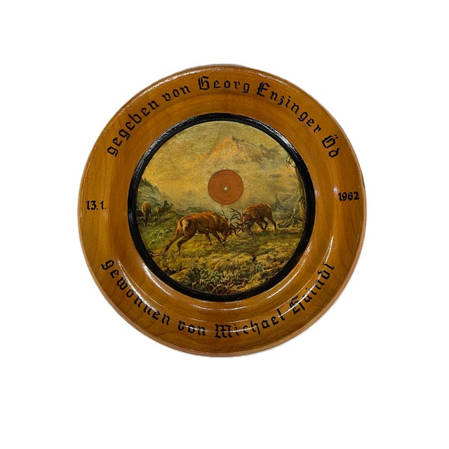 The German or Alpine shooting target is a round wooden plaque featuring a scene of two stags locking antlers in a mountain...