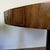Vintage Regency-style drum table with a tooled leather top and carved pedestal base. Features a walnut-veneered top with...