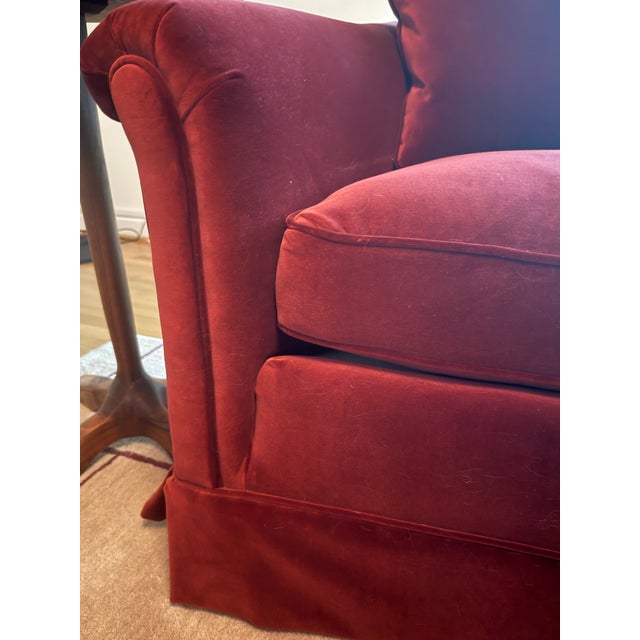 A curved mid-century sofa upholstered in a rich maroon Dutch cotton velvet. Solid wood frame. Includes four matching...