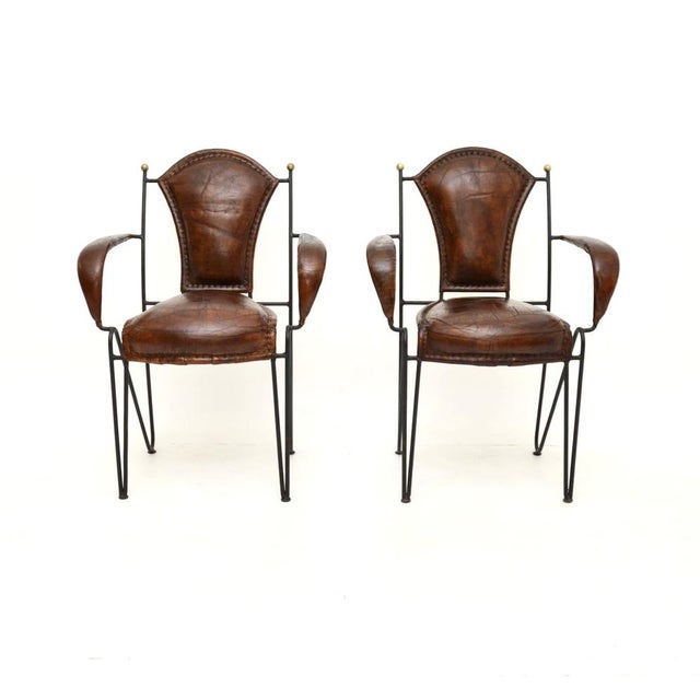 A stunning pair of vintage iron and leather armchairs by Frederic Weinberg, made in the USA and dating from around the...