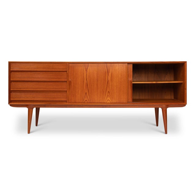 A true piece of mid-century Scandinavian history, this Model 18 credenza was designed by Gunni Omann for the family-owned...