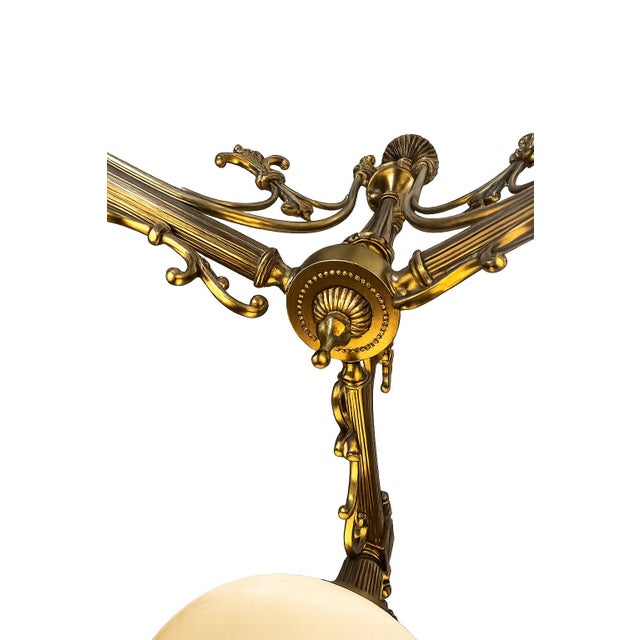 An elegant vintage three-light billiard chandelier featuring a beautifully detailed Neoclassical design with substantial...