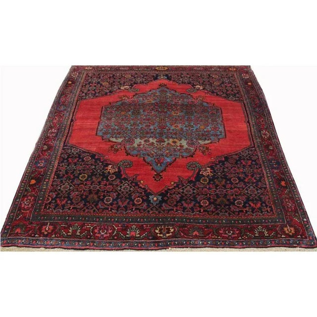 ACTUAL SIZE: 3’9″ x 5’1″ PRIMARY COLOR: Rust / Blue AGE: Antique MATERIALS: Wool FOUNDATION: Cotton PRODUCTION: Handwoven,...