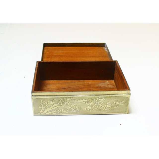 A silver-plated box with a naturalistic oriental decor from the first half of the 20th century The box is made of wood...