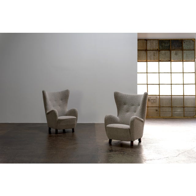 High-back wing chair by Mogens Lassen from the 1940s. These examples were made in the early 50s. Dark-stained beech wood...