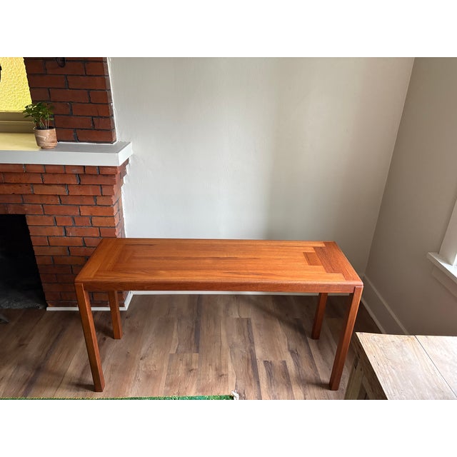 A refined mid-century Danish modern teak console table by Stole og Møbelfabrik A/S of Skanderborg, Denmark. Crafted in...