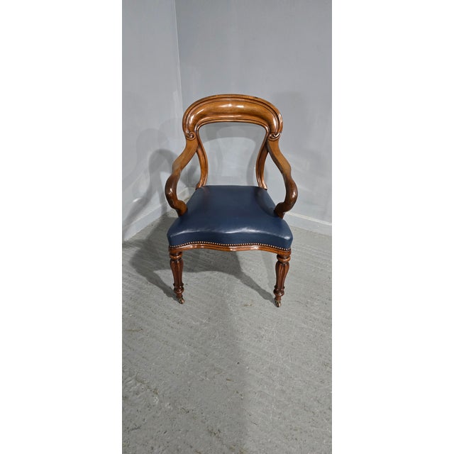 A superb quality early Victorian desk chair with blue leather serpentine fronted seat, in excellent overall condition. 37"...