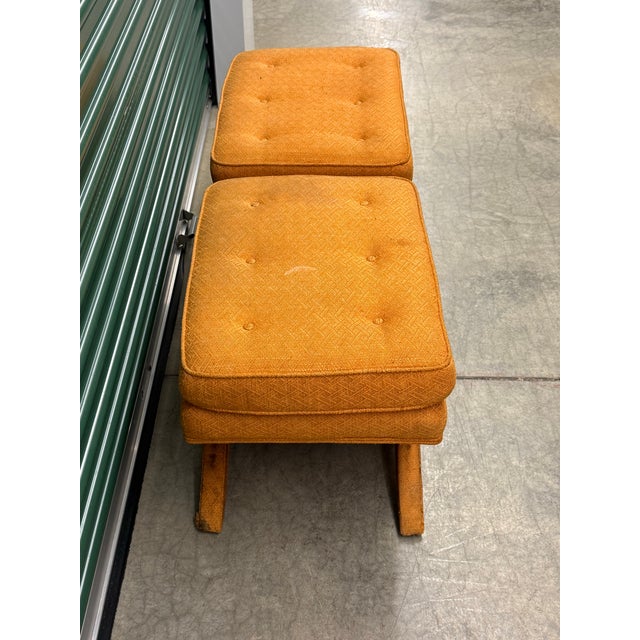 Striking pair of vintage circa 1970s fully upholstered X-base ottomans in the iconic Billy Baldwin style. The pair retains...