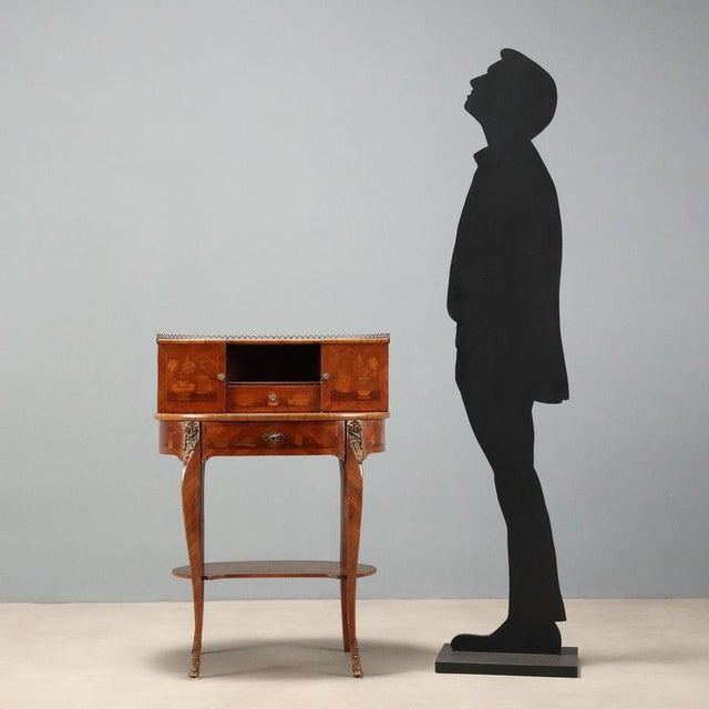 Small open writing desk in bois de rose, crafted in France at the beginning of the 20th century, featuring an elegant oval...