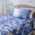 A free-flowing symmetrical pattern is cut-out in periwinkle cotton fabric and hand-sewn on sheer white cotton organdy to...