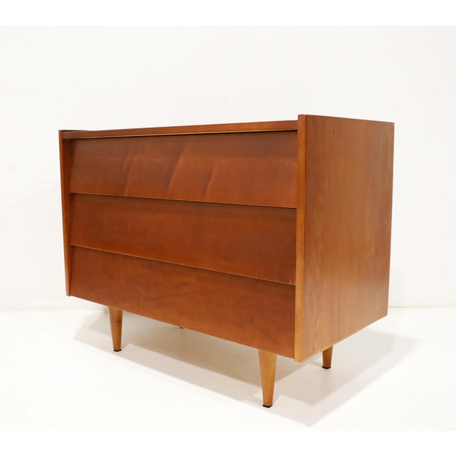 Beautiful chest of drawers or nightstand in an iconic design by Florence Knoll. Louvered drawers on raised turned wood...