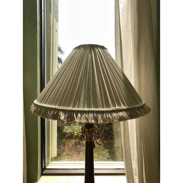 Elegant decorative floor lamp featuring a richly carved dark wood-style column with gilt accented details, ornate scroll-...