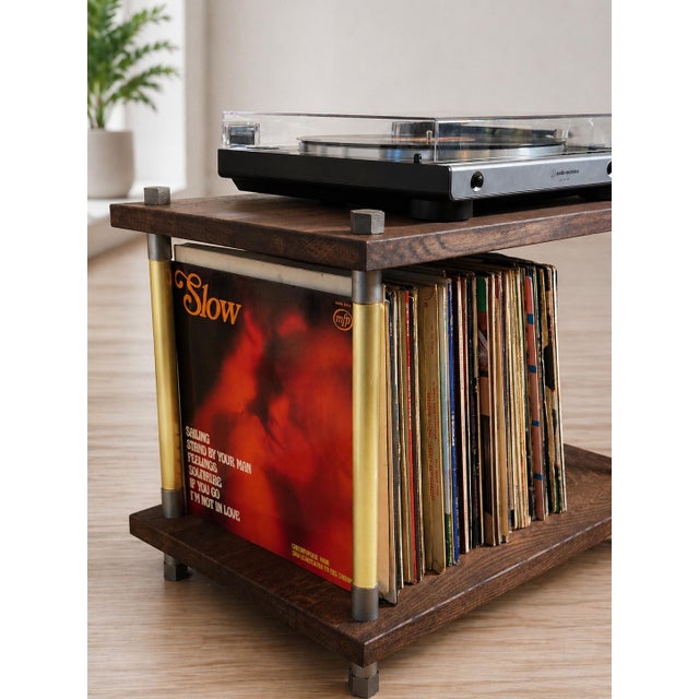 A handcrafted industrial turntable console with vinyl record storage, made from solid oak, real brass pipes, and steel...