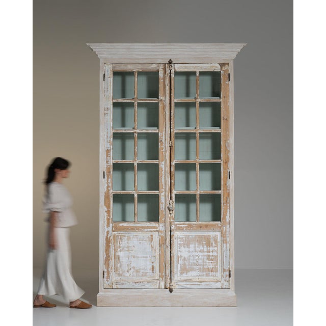 A cabinet whose distressed cream/white painted wood gives it real character at first glance. Dating to 20th Century and...