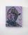 This artwork features a stylized helmeted figure, exuding an air of mystery and strength, surrounded by serpentine forms...