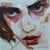 This artwork features a close-up portrayal of a face, characterized by striking eyes that convey a sense of intensity and...