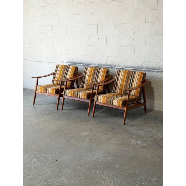 This handsome lounge chairs features a striking sculptural profile with gracefully curved armrests. The streamlined frames...