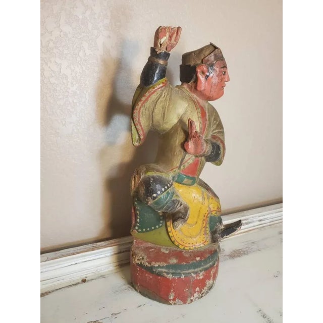 An antique Chinese hand carved wood temple figure dating to the 19th century. Richly detailed, vibrant polychrome...
