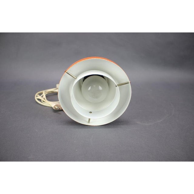 A striking 1970s Czechoslovakian wall lamp designed by Josef Hurka for Napako. The lamp combines a vivid orange lacquered...