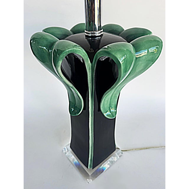 Lucite and Table Lamp with Ceramic Leaves Opening from a Black Stem Offered for sale is a decorative table lamp made of...