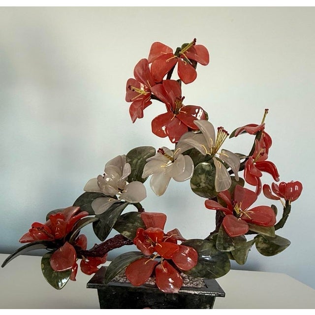 This antique jade tree is a striking home décor accent, valued for its age, character, and sculptural form.