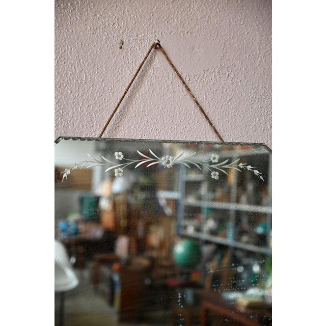 This generously sized mirror, with its beveled edge and floral engraving, exudes a delightful bohemian charm. Suspended by...
