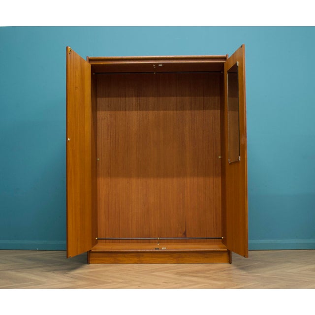 A well-proportioned mid-century teak wardrobe by Bath Cabinet Makers, with clean lines, warm grain and quality British...