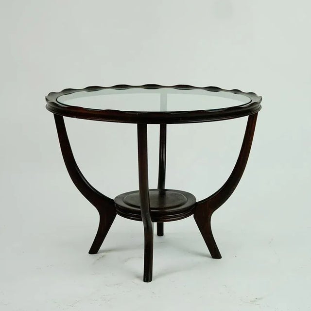 This charming circular Mid-Century coffee or side table was designed and manufactured in Italy in the 1950s. It's style is...
