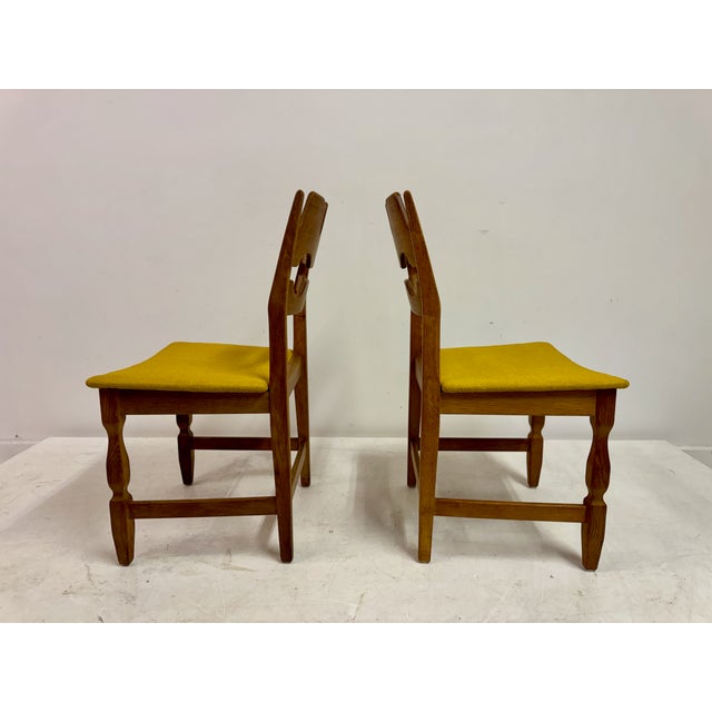 A set of six dining chairs designed by Henning Kjærnulf, crafted in solid oak and dating from the 1960s. The chairs...