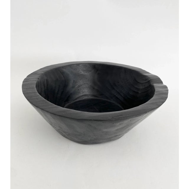 Artisan carved teak wood bowl with beautiful grain that shows through the black finish. Thick 1.25" walls taper down to a...