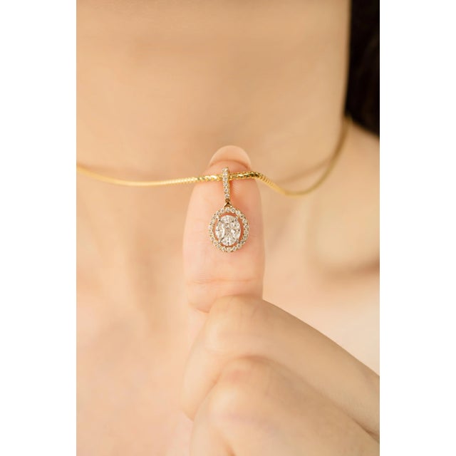 Crafted in radiant 14K yellow gold, this elegant oval halo pendant features 0.46 carats of round brilliant cut diamonds in...
