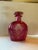 A graceful cranberry glass liquor decanter of flattened, gently waisted form, hand-engraved on the front panel with a...