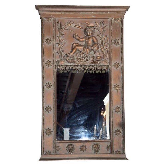 French Neoclassical-style, distressed trumeau mirror. The top panel features a cherub decoration over a rectangular...