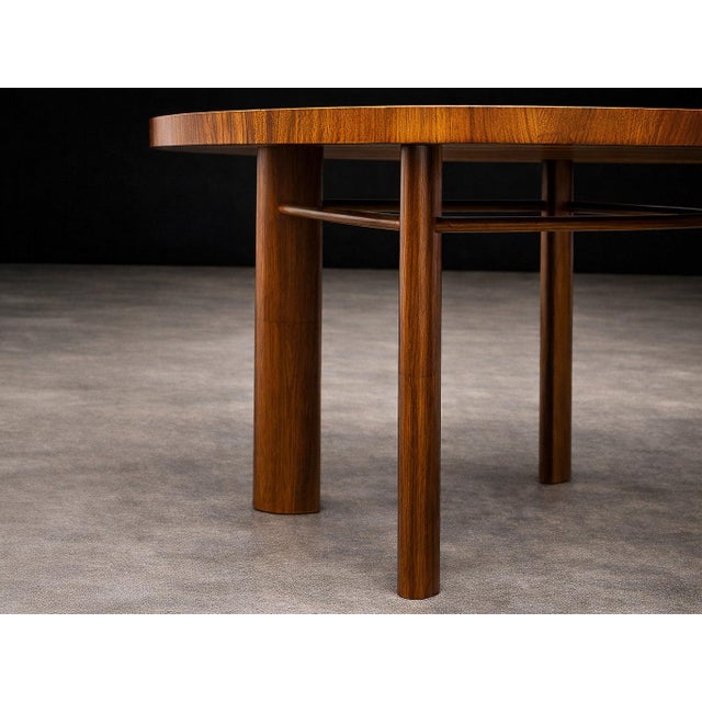 Designed in the 1950s by Joaquim Tenreiro, this exceptional round dining table represents a mature expression of Brazilian...