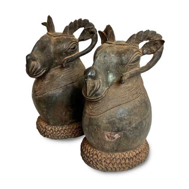 Cast using the ancient lost-wax technique, these striking bronze ram head sculptures originate from the metalworking...