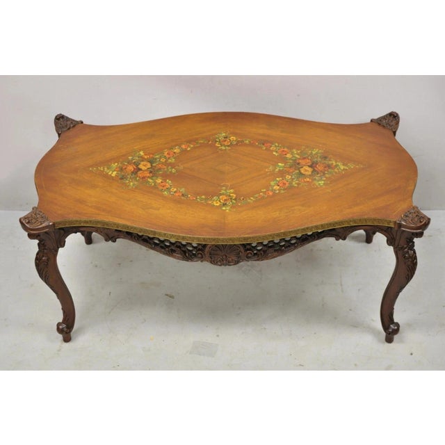 Vintage French Louis XV Style Walnut Coffee Table with Hand Painted Floral Top. Item features pierce carved fretwork...