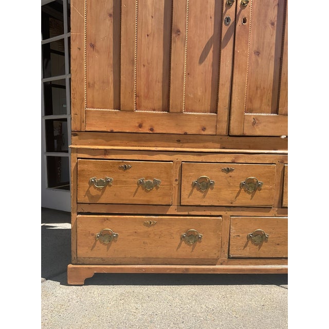 Antique pine cabinet that comes in two pieces (Upper Cabinet has adjustable shelves, and the lower part of the cabinet has...