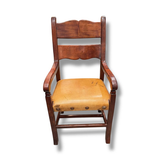 Rustic Mexican-style armchair crafted from rich stained wood with beautifully curved lines and timeless hacienda charm....