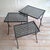 This set of side tables (nesting tables) is made of wrought iron, black with gold-colored accents. Equipped with glass...